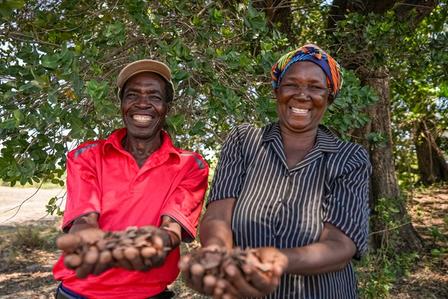 Woman and man holding seeds.
