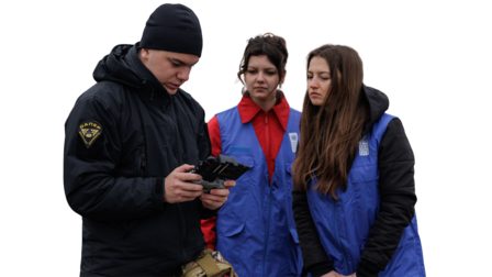 Photo shows group of people in blue jackets.