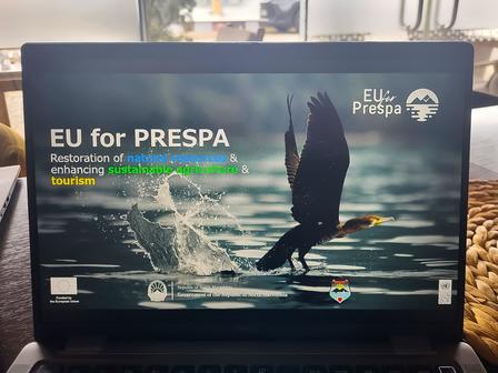 Laptop screen shows EU for PRESPA presentation with water splash and a dark figure near rocks.