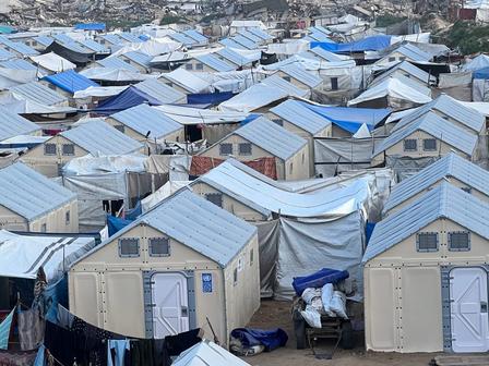 Dense cluster of blue-roofed shacks in an informal settlement.