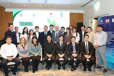 Group of colleagues at a training program posing for a photo with a TRAINING banner.