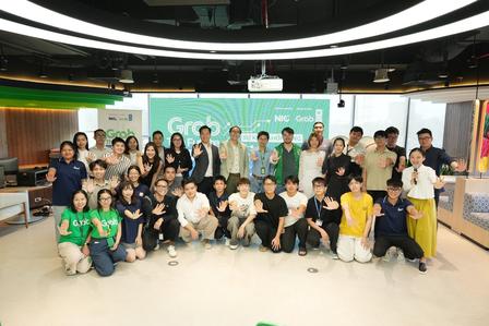 Diverse group posing for a team photo in a bright, modern office.