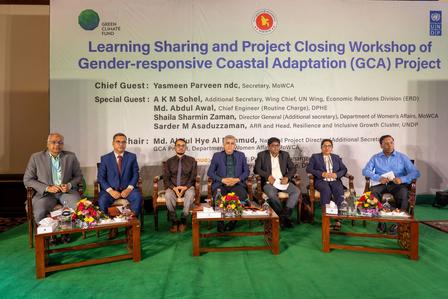 Panelists on stage at a workshop closing; banner for Gender-responsive Coastal Adaptation Project.