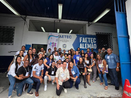 Group of people posing in front of banners.
