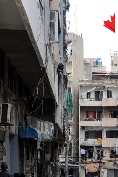 a narrow city street with buildings in the background
