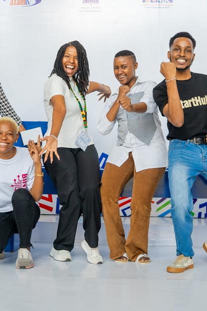 Diverse group posing together in a bright studio, smiling.