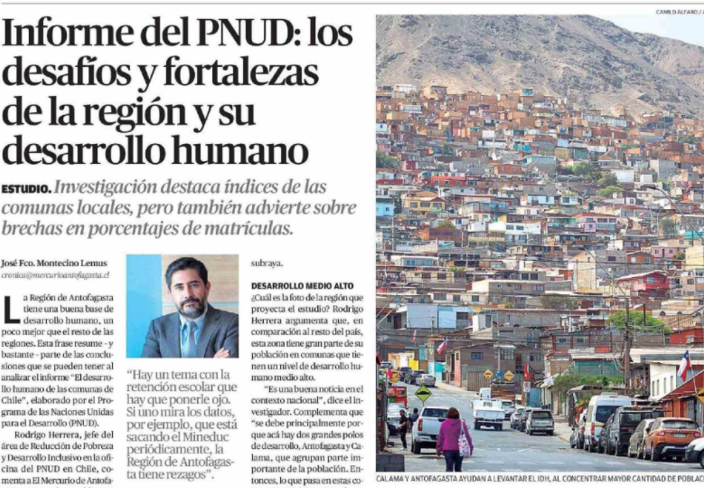 A newspaper article featuring a mountainous landscape with colorful houses and some pedestrians.