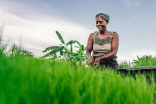 a man sitting on top of a grass covered field