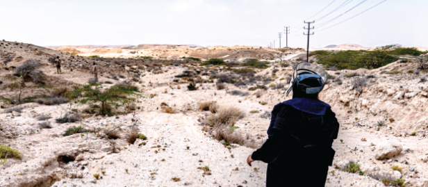 Woman deminer at a desert location
